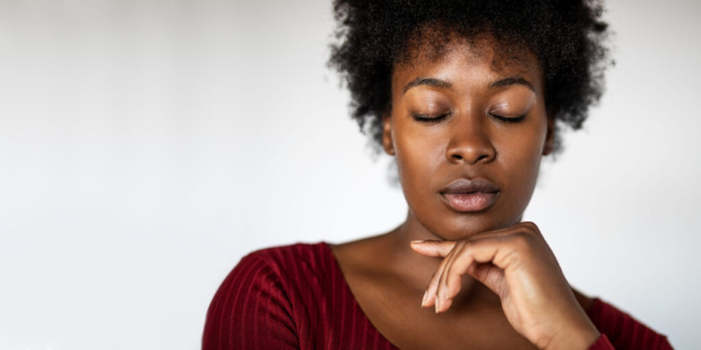 Woman with hand on chin lost in concentration