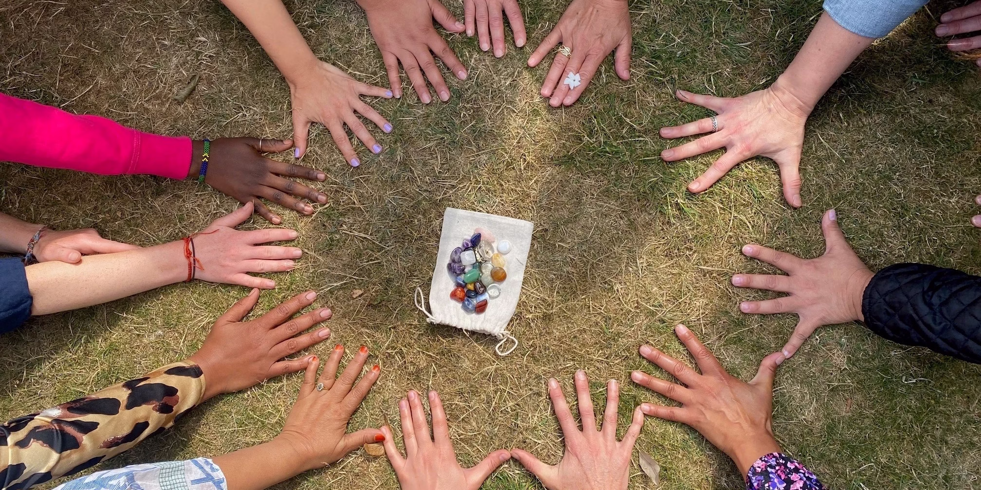 Photo of the hands of the participants in a circle at the end of the third session for refugees and asylum seekers